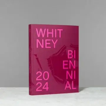 The 2024 Whitney Biennial program book standing on a countertop